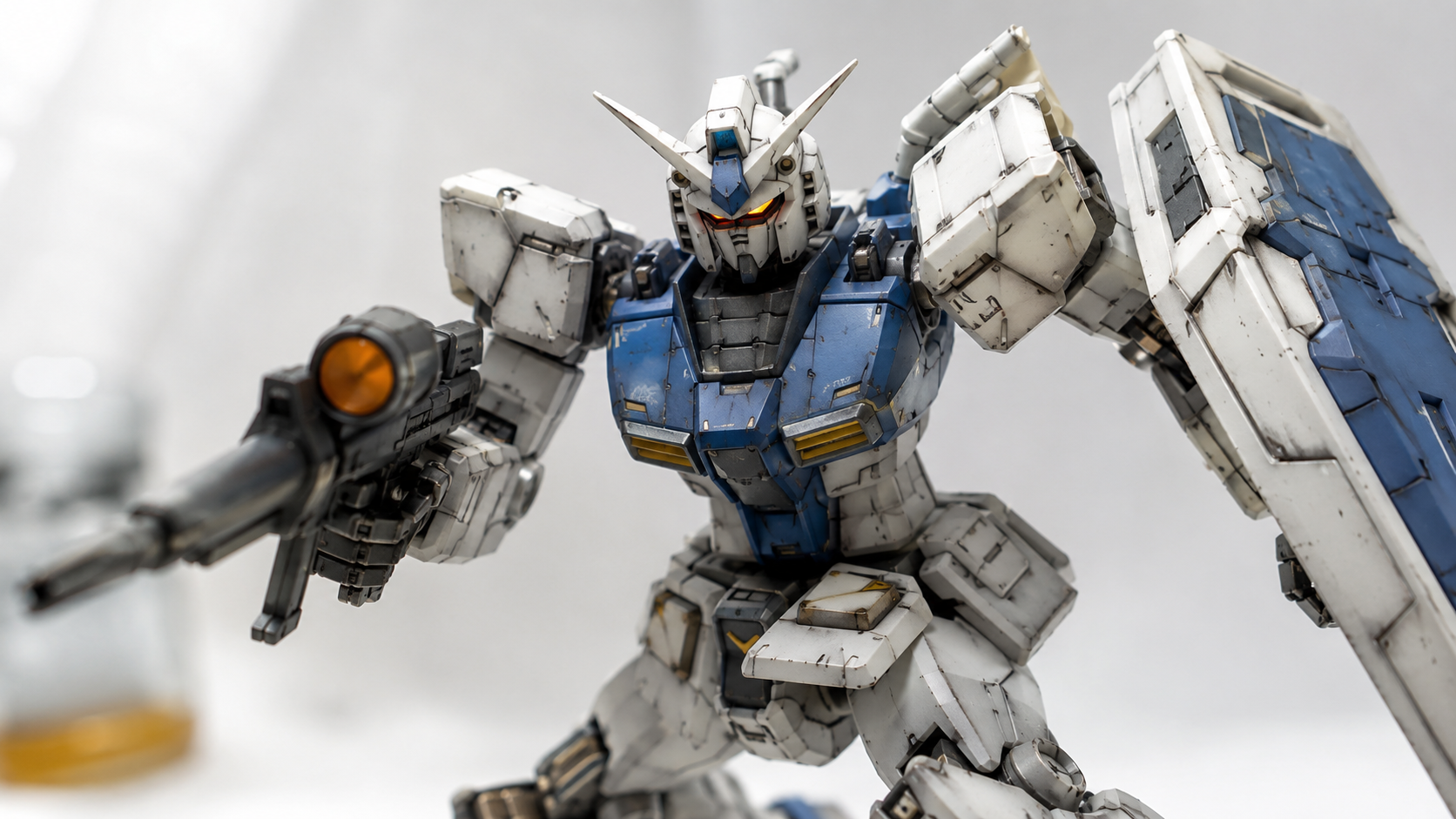 Fully painted and weathered 3D printed Gundam figure with panel lines, white and blue armor, and dynamic pose