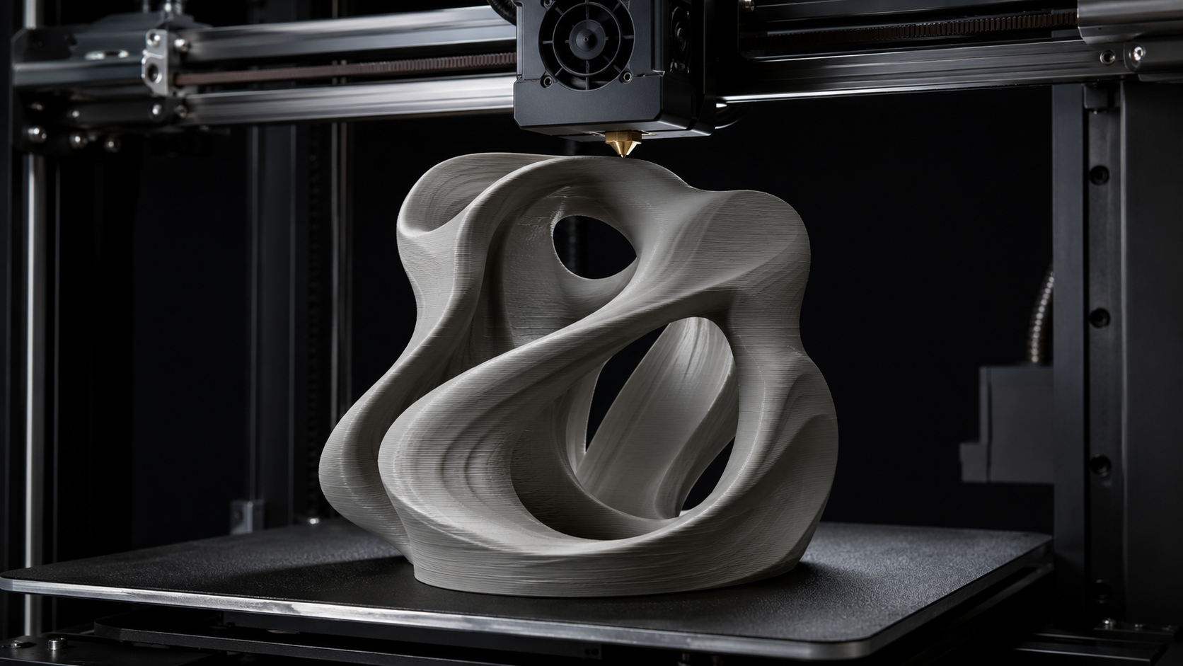 3D printed abstract sculpture on printer build plate showing additive layer lines