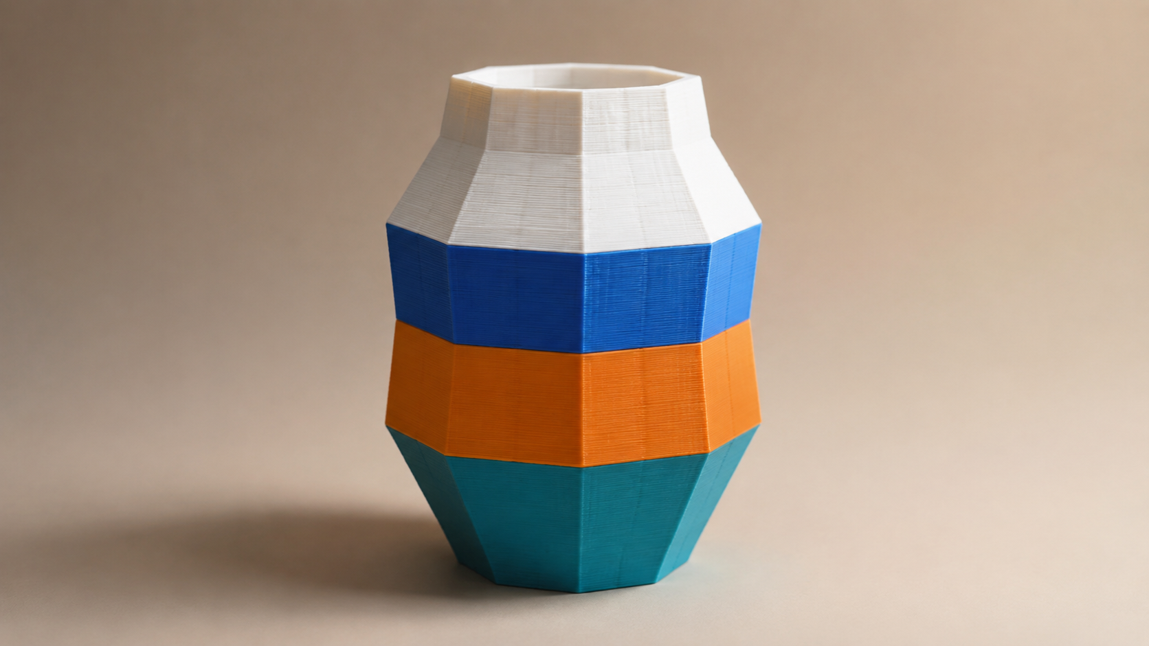 A geometric 3D printed vase with crisp horizontal color bands representing slicer color painting