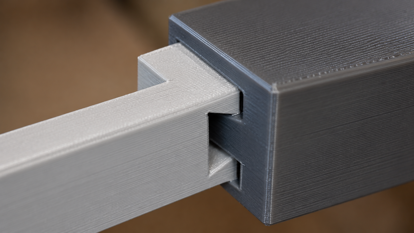 Close-up macro of a dovetail pin and tail joint between two 3D printed parts